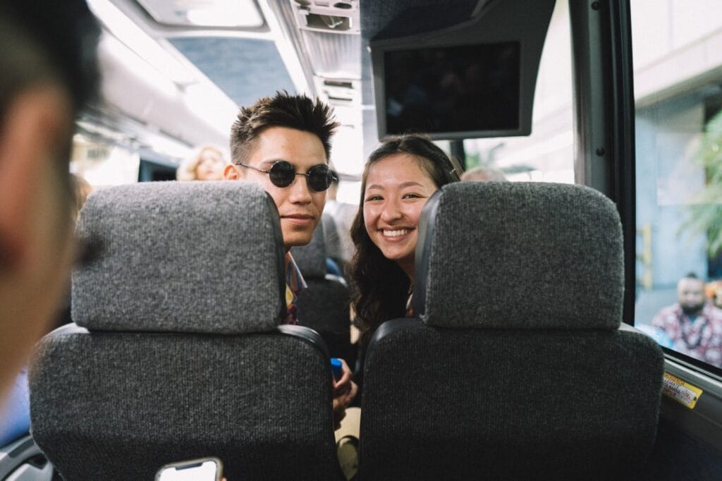young-couple-traveling-on-a-bus-e1656574261102